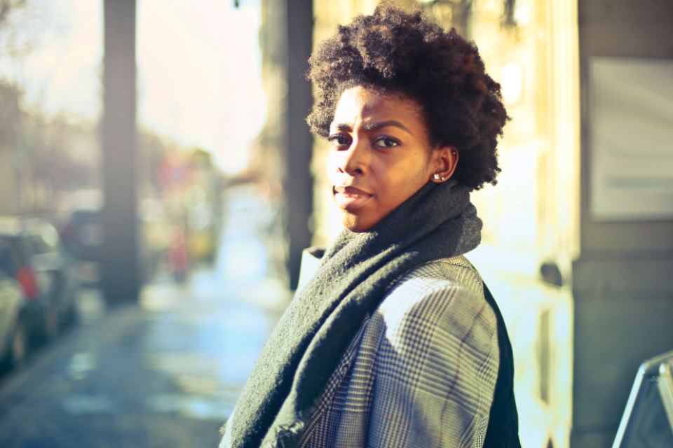 Model in a checked blazer and chunky scarf