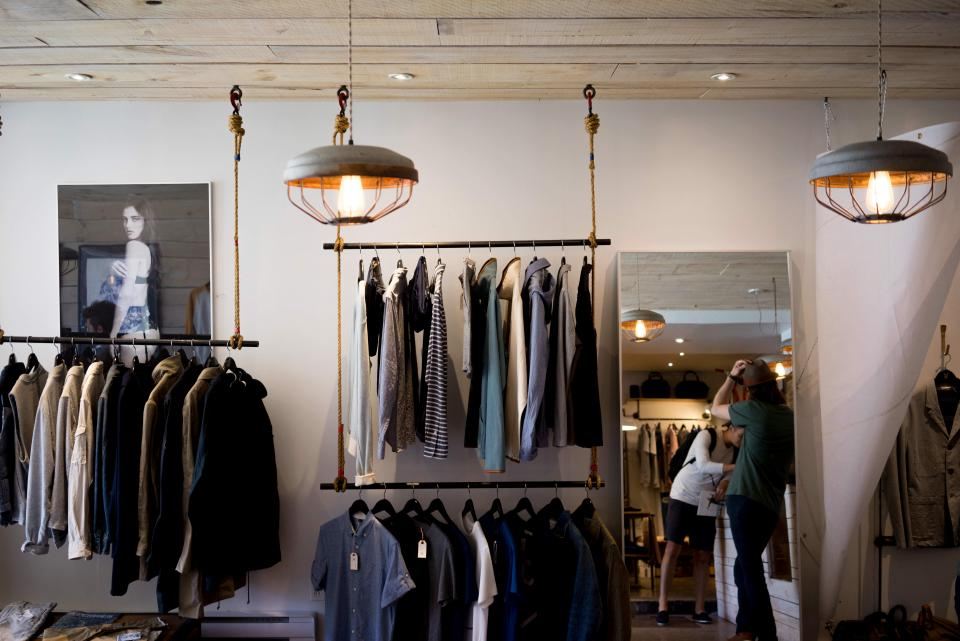Inside the Northweave store with clothes on hanging rails