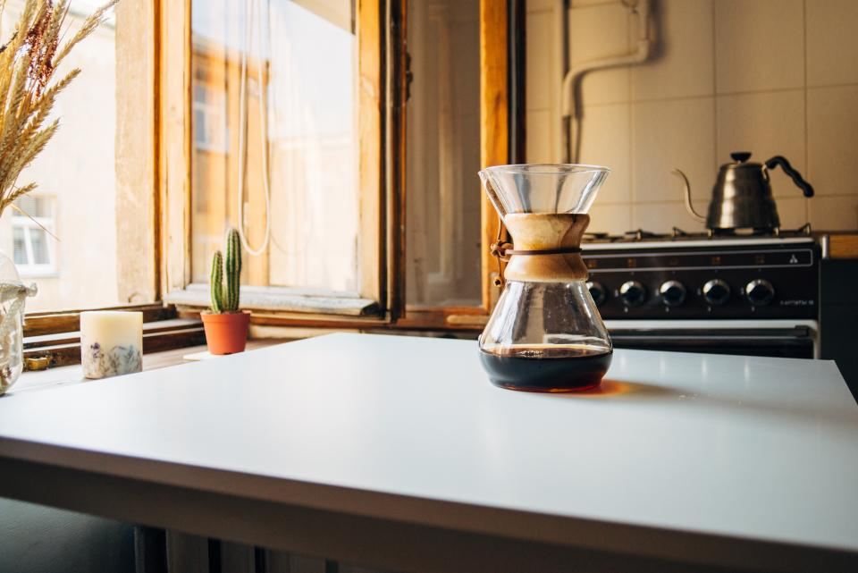 Sunlit kitchen counter by a timber-framed window